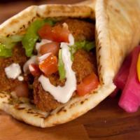 Falafel Wrap · Falafel patties with tomatoes, onion, cucumber  and lettuce on pita bread. Pick your sauces.