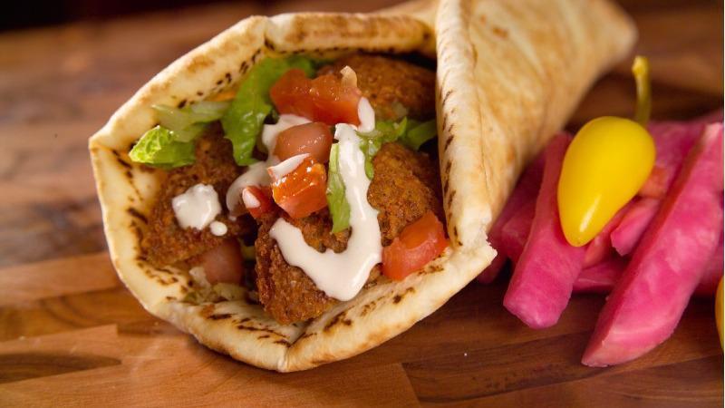 Falafel Wrap · Falafel patties with tomatoes, onion, cucumber  and lettuce on pita bread. Pick your sauces.