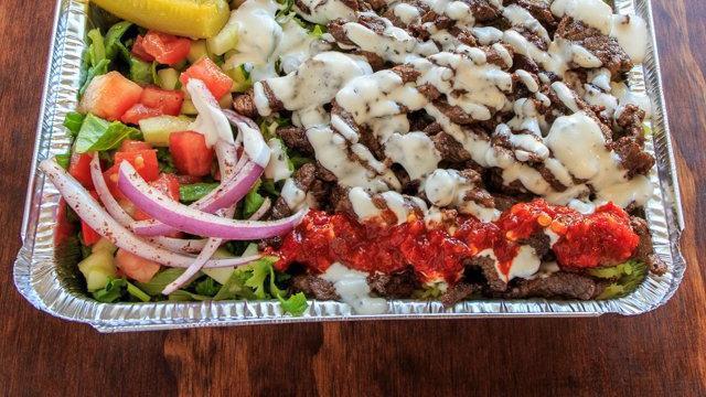 Beef Shawarma Plate · Beef Shawarma comes with rice, veggies (lettuce, tomatoes, pickle, onion, cucumber) and pita. Pick your sauces.