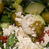 Greek Salad · Lettuce, onions, tomatoes, cucumber, pickles, olives, feta cheese.