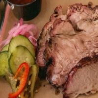 Coffee Grind Smoked Brisket · Our signature brisket is rubbed with love and coffee grind. Served with bbq sauce, pickled o...