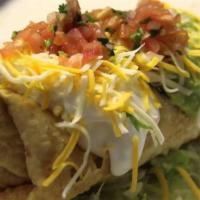 Nachos Sabrosos · Tortilla chips topped with refried beans, chile con queso, lettuce and tomatoes.