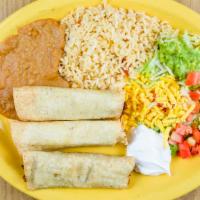 Flautas · Three rolled corn tortillas stuffed with chicken, topped with guacamole and sour cream, serv...