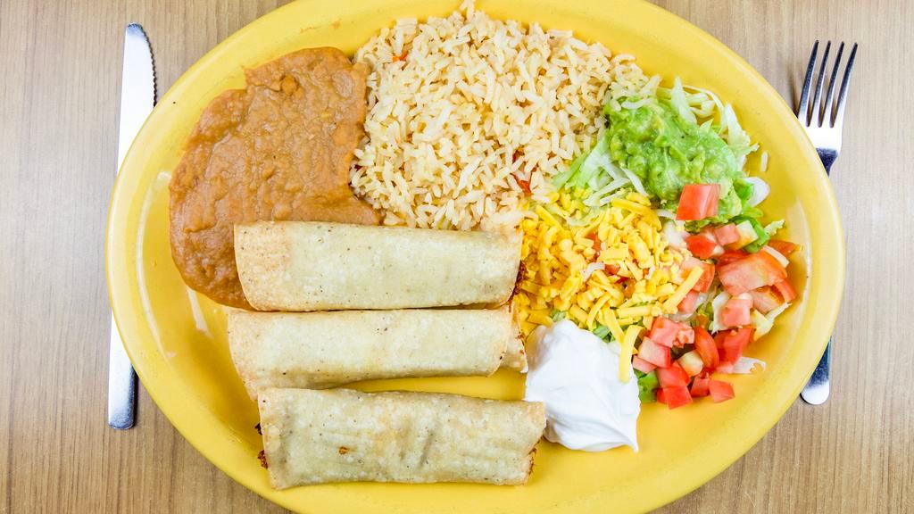 Flautas · Three rolled corn tortillas stuffed with chicken, topped with guacamole and sour cream, served with rice, beans, cheese and tomatoes.