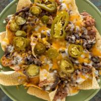Nachos · Served with beans, cheese, and your choice of meat.