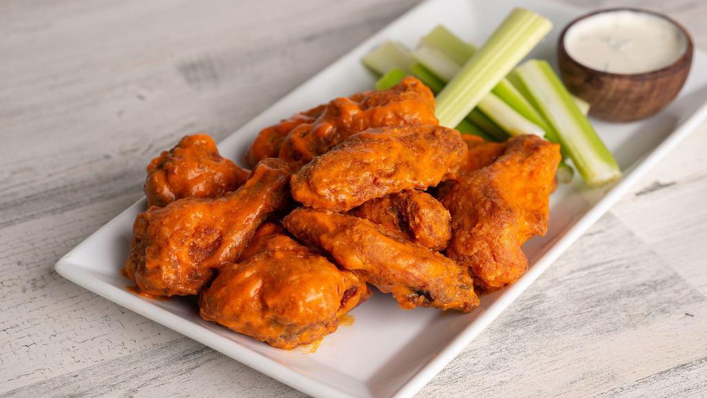 Buffalo Wings · Ten deep-fried crispy wings tossed in medium buffalo sauce. Served with celery sticks and a side of blue cheese or ranch dressing