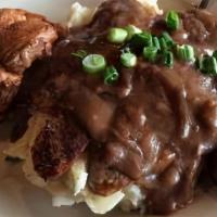 Bangers & Mash · Two traditional English sausages. Served with mashed potatoes and a Yorkshire pudding smothe...