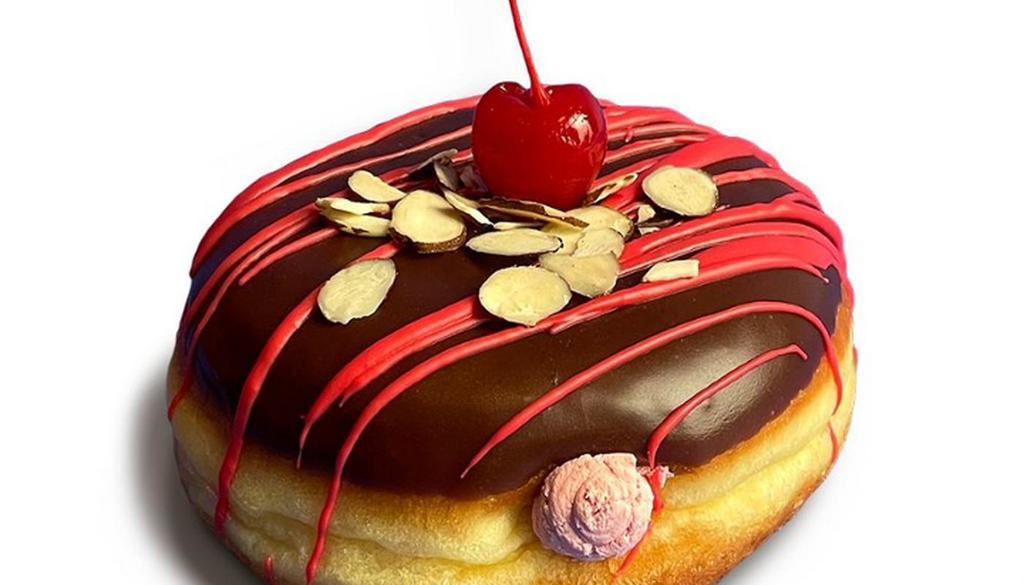 Cherry Time · Raised doughnut coated in smooth chocolate icing, filled with whipped cherry filling, finished with a drizzle of almond icing and slices and topped with a maraschino cherry