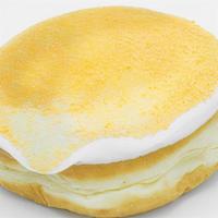 Mango Tango · Raised yeast shell filled with mango jelly and topped with vanilla frosting and Tang.