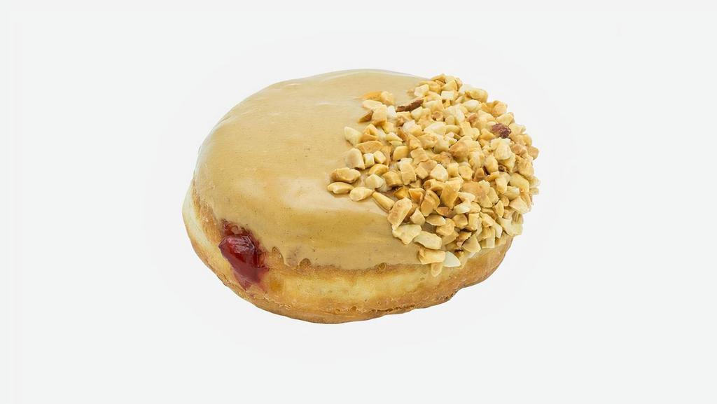 Vegan School Daze · Vegan raised yeast shell filled with raspberry jelly, topped with peanut butter and a side dip of peanuts.