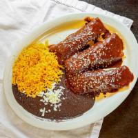 Enchiladas Con Mole · Three shredded chicken enchiladas topped with mole sauce, served with rice and black beans.