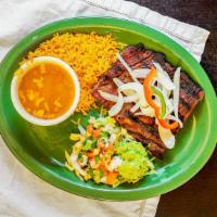 Carne Asada · Flat steak topped with grilled onions and bell pepper served with frijoles charros, rice, gu...