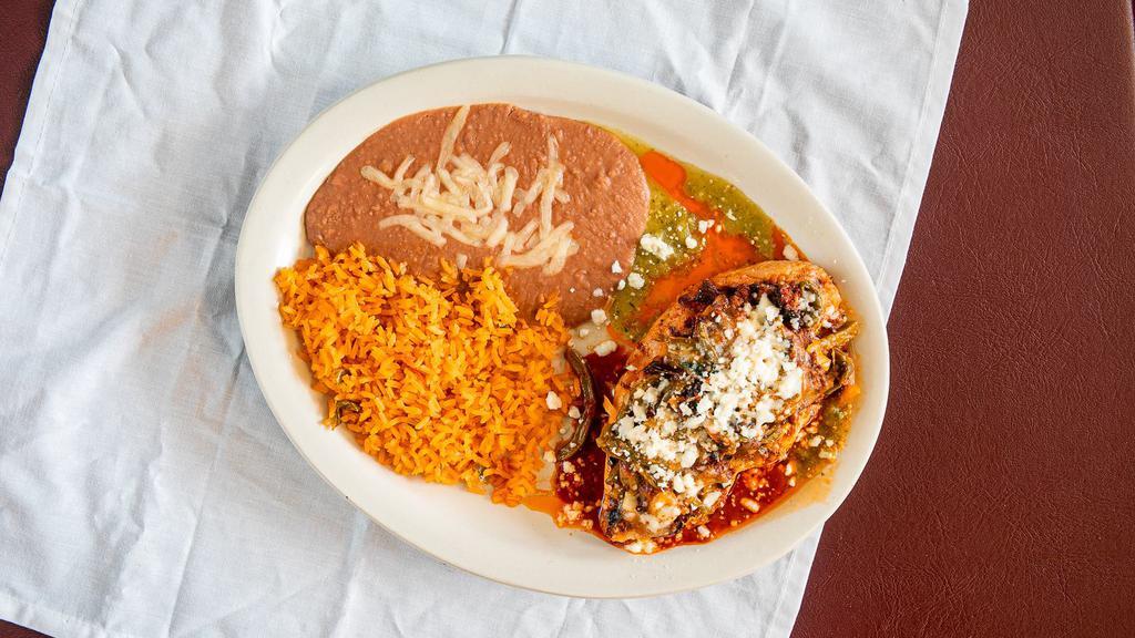 Pollo Mestizo · Grilled chicken breast cooed on Morita sauce tomatillo sauce, topped with nopalitos (cactus) chorizo and queso fresco served with Mexican rice and duck beans