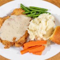 Chicken Fried Chicken · Hand-breaded chicken breast topped with creamy white gravy served with vegetable, Roll and c...