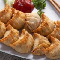 Street Chicken (Deep Fried) · Handcrafted Chicken Momo served deep-fried with Homemade Tomato Dipping Sauce (Achar).
