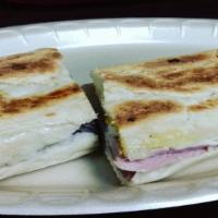 Cuban Sandwich · Traditional Cuban pressed sandwich with mustard, pickles, Swiss cheese, ham and pork on Cuba...