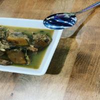 Goat Meat Pepper Soup · Goat meat mixed with broth and spices.