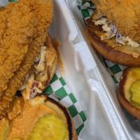 Cajun Catdaddy · Hand-battered catfish paired with spicy coleslaw and pickles between two toasted brioche bun.