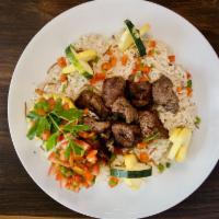 Steak Kabob Rice Plate · Filet Steak Kabob pieces served with Rices and Side Veggies (Tomatoes, Onions & Pickles). Ta...