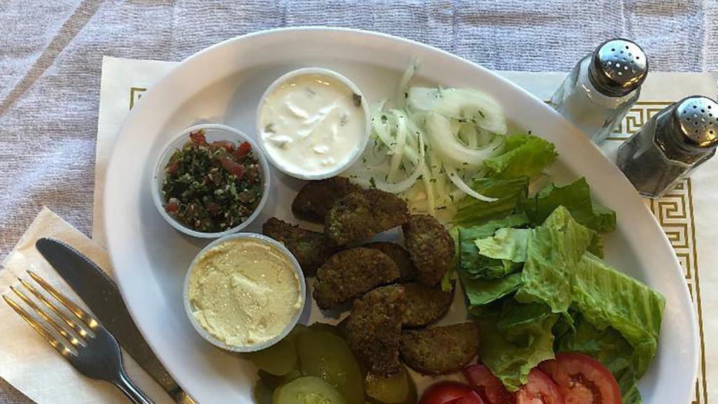 Veggie Plate · Mushroom with cheese or Falafel. Cooked on open fire. Served with hummus, tabuli and tzatziki sauce. Comes with one Bread