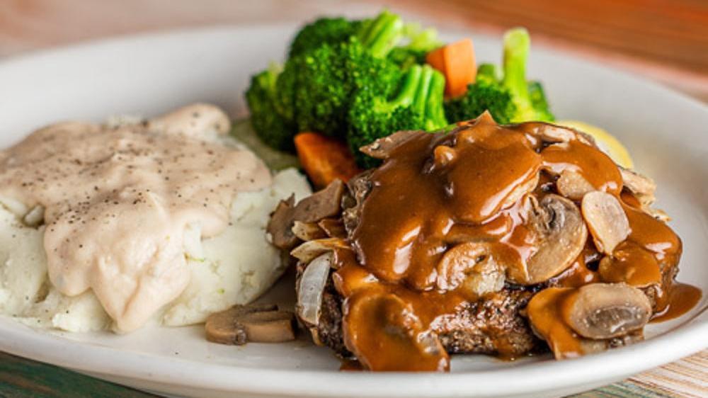 Smothered Chopped Steak · 8oz chopped steak topped with grilled onions and sautéed mushrooms. Choice of two sides.