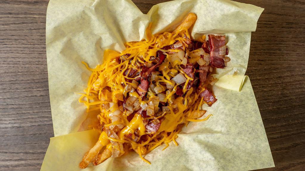 Loaded Fries · Fries with melted cheese, chopped bacon and grilled onions.