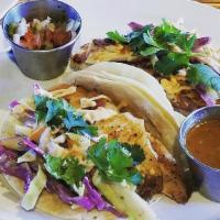 Fish Tacos · Grilled Cod on Corn Tortillas with Creamy Avocado Slaw, Gochujang Mayo.  Served with Salad a...