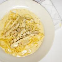 Fettuccine Alfredo · Fettuccine pasta & garlic tossed in a rich Parmesan-cream sauce