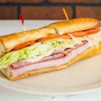 Po Boy Sandwich · Ham, salami, & Provolone cheese, lettuce, tomatoes, & onions, on  a lightly toasted baguette...