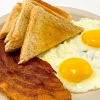 Two Eggs Any Style · Choice of bacon, ham, sausage, or smoked sausage, and toast or a hot biscuit and gravy.