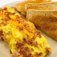 Three Egg Omelette · Served with ham and cheese with a choice of toast or a hot biscuit and gravy.
