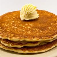 Three Buttermilk Pancakes · Served with whipped butter and syrup.
