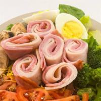Chef Salad · Mixed greens with tomatoes, broccoli, mushrooms, a hard boiled egg, and cheese, topped with ...