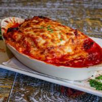 Lasagna · Layered pasta sheets with Italian sausage, ground beef, ricotta cheese, mozzarella cheese, a...