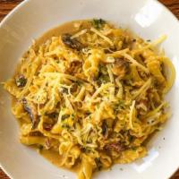 Campanelle Alla Panna · Campanelle tossed in a light parmesan, prosciutto, and mushroom sauce topped with green onio...