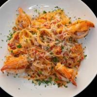Fettuccine Di Mare · Fettuccine, jumbo shrimp, calamari, roasted garlic, white wine, and our tomato arrabbiata sa...