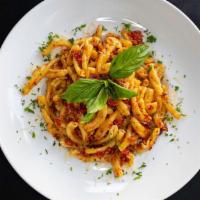 Casarecce Al Pomodoro · Casarecce, fresh Roma tomatoes, roasted garlic sauce, topped with parmigiano