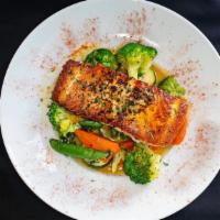 Salmone Al Limone · A garlic herb marinated salmon fillet, pan-seared and drizzled with our orange and lemon