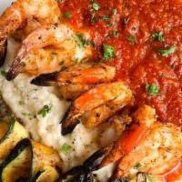 Gamberoni Alla Griglia · Grilled jumbo shrimp on a bed of homemade tomato arrabbiata sauce served with grilled zucchi...