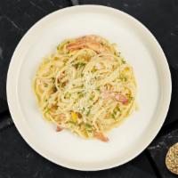 Shrimp Scampi · Sauteed shrimp with garlic and herbs in a white wine lemon butter sauce over linguine