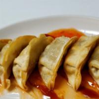 Gyoza · 6 pieces. Pork and vegetable dumplings with spicy orange marmalade.