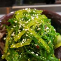 Seaweed Salad · Marinated seaweed salad over cucumber and spring mix topped with sesame seed.