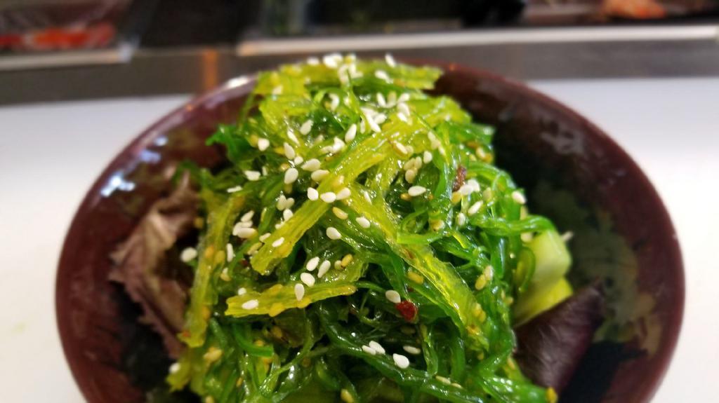 Seaweed Salad · Marinated seaweed salad over cucumber and spring mix topped with sesame seed.