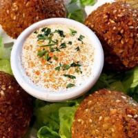 Falafel (5 Pcs) · Deep fried chickpeas mixed with parsley, onions, garlic & cilantro.