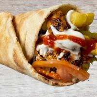 Lebanese Chicken Shawarma Wrap · Pita wrapped with chicken shawarma, fries, tomatoes, pickles, ketchup & garlic sauce.