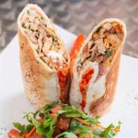 Chicken Shawarma Wrap · Marinated spiced chicken shaved off a rotating pit, wrapped in pita bread with lettuce, toma...