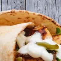 Chicken Shawarma Wrap · Marinated spiced chicken shaved off a rotating spit wrapped in pita bread with lettuce, toma...