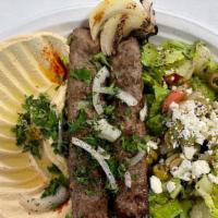 Lamb Kabob · 2 skewers of ground lamb mixed with onion & lamb spices served with grilled tomato & onion. ...