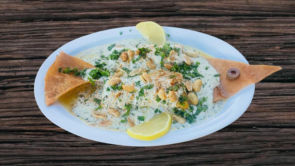 Samke Harra: Lebanese Spicy Tahini Fish · Grilled fish fillet wild salmon topped with tahini sauce, lemon, chopped parsley, garlic & peanuts. Served with 2 sides.