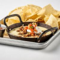 Skillet Queso · Topped with smoked brisket, sour cream, and pico de gallo, served with choice of tortilla or...